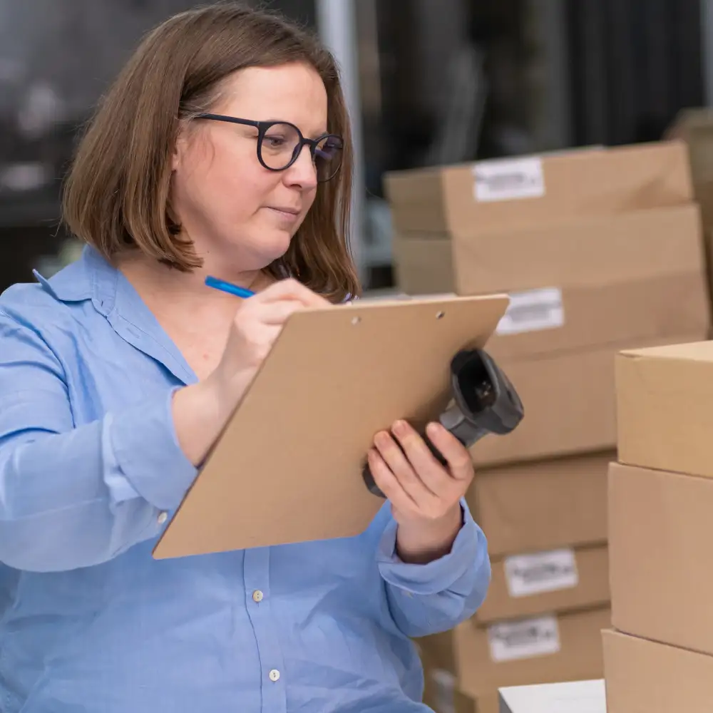 warehouse manager inspecting damaged boxes